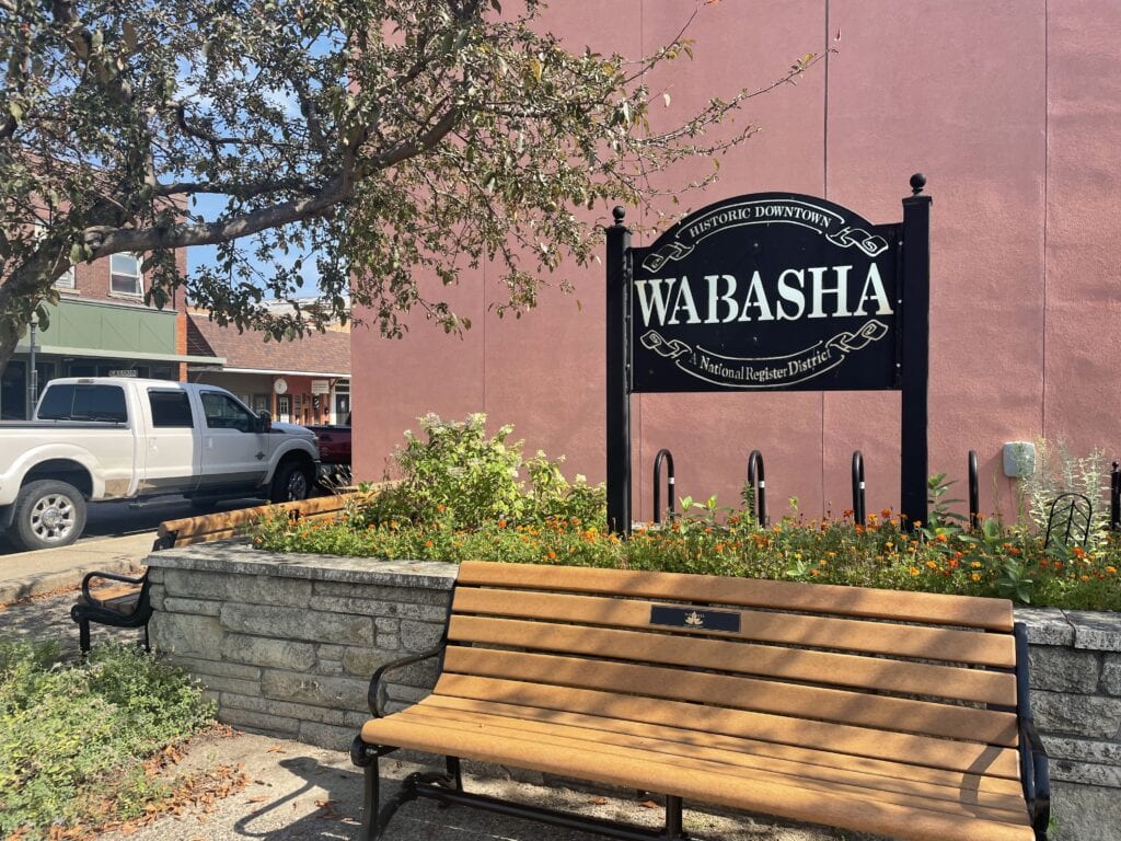 Homepage 2024 Image: Wabasha Main Street Bench next to the Historic Wabasha sign